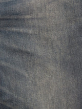 Close-up view of blue denim fabric from the Blue de Gênes Vinci Topaz Vintage Jeans – Used, highlighting the intricate weave pattern and subtle color variations characteristic of comfort stretch denim.
