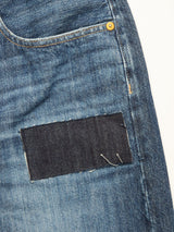 Close-up of the Giacomo Osaka Jeans - Dark Denim by Blue de Gênes, featuring a relaxed loose fit with a dark denim rectangular patch sewn onto the thigh area near the pocket and visible yellow stitching.
