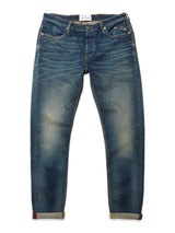 The Repi Dark Vintage Jeans by Blue de Gênes are slim-fit, mid-blue denim jeans with a vintage wash, faded and worn look, rolled cuffs, visible stitching, and front/back pockets shown laid flat on a white background.