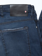 Repi BlueBlk Used Jeans by Blue de Gênes in blue black comfort stretch denim, offer a regular slim fit. Features include a black leather Blue de Gênes patch with red and white shield emblem, plus highlighted back pocket and waistband details.