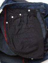 A close-up of Blue de Gênes Repi BlueBlk Used Jeans - Blue Black Denim shows black pocket lining with white care instructions and metal rivets securing the pocket to the comfort stretch denim fabric.