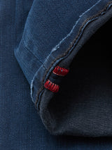 Close-up of the hem of Blue de Gênes Repi BlueBlk Used Jeans in blue-black denim, featuring the inside seam with distinctive red and white stitching on comfort stretch fabric.