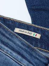 A close-up of Blue de Gênes Recco Blue Vintage Jeans - Vintage Wash denim shows a "Made in Italy" label with the Italian flag. The stitching and texture highlight the relaxed fit and quality craftsmanship.