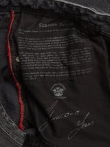 Inside view of Giacomo BLK Used Jeans in grey denim by Blue de Gênes, featuring printed text about Giacomo Jeans, red stitching, brand logos, and a bold signature print reading "Giacomo Jeans." Expertly crafted in Italy for superior quality.