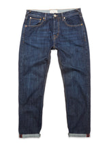 The Giacomo Dark Horse Jeans - Denim Blue by Blue de Gênes are a pair of dark blue, relaxed loose fit jeans featuring rolled-up cuffs, visible front pockets, belt loops, and a button closure. Crafted from rigid denim and made in Italy, they are displayed laid flat against a white background.