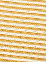Close-up of the BGbob Knit Polo - Sunflower by Blue de Gênes, showcasing its textured fabric with alternating horizontal gold and white stripes. The evenly spaced stripes run diagonally across the image, creating a patterned, tactile surface reminiscent of a classic nautical shirt.