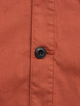 Close-up of the BGpontus Teo Overshirt in Copper Brown by Blue de Gênes, highlighting its textured cotton fabric, center-fastened black button, and detailed stitching.