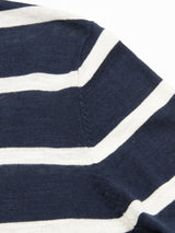 Close-up of the Monte Stripe Knit - Navy by Blue de Gênes, showing navy fabric with white stripes and a detailed seam with visible stitches and texture.