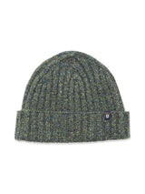 The Oscar Melange Beanie - Forest by Blue de Gênes is a green ribbed knit beanie with subtle multicolored specks, a folded cuff, and a small rectangular front patch featuring a shield emblem.