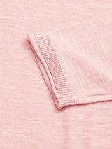 Close-up of Blue de Gênes Monte Knit in Porcelain Pink, highlighting the textured fabric and stitching. A slightly raised pocket is positioned diagonally, showcasing detailed craftsmanship.