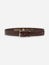 The BGathol Belt - Dark Brown by Blue de Gênes is displayed laid flat, showcasing its dark brown full-grain leather and classic metal buckle. The interior features gold text and a crest, indicating the size and that it is handmade in Italy.