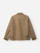 The BGcuddy Nebraska Jacket - Brown by Blue de Gênes is a khaki-colored workwear jacket viewed from the back, featuring long sleeves, a collar, black buttons on the cuffs, and adjustable button tabs at the hem. Made from high-density cotton for exceptional durability and structure.