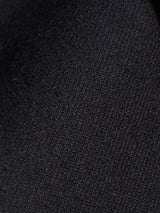 Close-up of the Canna Carbonio Gillet - Black by Blue de Gênes, highlighting its black fabric with detailed woven texture and subtle shading variations.