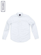 The BGsandro Oxford Shirt - White by Blue de Gênes, a classic white button-down with a chest pocket, is displayed flat on a white background. A label in the top left corner reads THE CLASSICS.