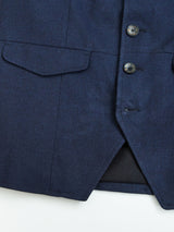 Close-up of the Blue de Gênes Casella Officers Blazer in Dark Navy, featuring three dark buttons, buttonholes, and a flap pocket on the left side with the jacket partially open at the bottom.