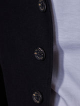 Close-up of the Casella Officers Blazer in black by Blue de Gênes, featuring shiny black buttons reminiscent of a vintage parade uniform, with part of a white shirt visible underneath.
