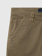 Close-up of Blue de Gênes BGpaulo Pavia V3 Chino - Beech Green pants, featuring a diagonal front pocket and a small shield-shaped logo near the pocket opening.
