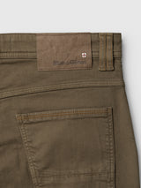 Close-up of the back waistband and pocket of olive green enzyme-washed BGpaulo Pavia V3 Chino - Beech Green pants, featuring a leather-look brand patch with a small cross logo.