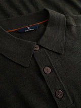 Close-up of the Blue de Gênes BGigor Polo Knit in Beech Green—a dark green, long-sleeved polo shirt featuring three brown buttons and a label inside the collar, crafted in a fine-gauge knit for a refined finish.