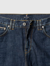 Close-up of the waistband and upper section of the Blue de Gênes BGmarco Cast Jeans in a denim wash, featuring visible stitching, metal button, belt loops, and front pockets. The Blue de Gênes label is visible inside the waistband, emphasizing the relaxed fit design.