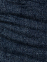 Close-up of Blue de Gênes BGmarco Cast Jeans in Denim wash, highlighting the dark blue cotton denim fabric with visible stitching and texture, featuring natural creases and folds reminiscent of worn-in jeans.