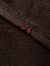 Close-up of the Hot Fudge Brown fabric from the BGpaulo Ottawa V3 Trousers by Blue de Gênes, showing a folded edge with two parallel red stitches on the hem. The dobby corduroy texture and weave are clearly visible, highlighting the meticulous craftsmanship of this regular slim fit style.
