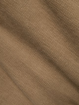 Close-up of sepia tint brown textured fabric with diagonal folds and visible weave pattern, characteristic of the BGpaulo Ottawa V3 Trousers by Blue de Gênes in a regular slim fit style.