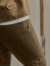 Close-up of olive green, enzyme-washed cotton stretch BGpaulo Pavia V3 Chino - Beech Green, featuring a small decorative metal stud detail on the front pocket.