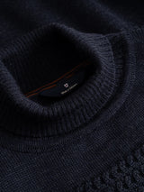 Close-up of the navy blue textured knit collar on a BGstu Rollneck Knit - Navy sweater.