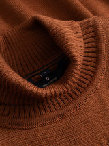 Close-up of a rust-colored, textured BGstu Rollneck Knit - Ginger Bread Orange.