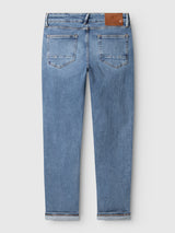 Back view of regular fit Blue de Gênes BGvinci Pala Used V3 Jeans in denim blue, featuring a brown leather patch on the waistband and cuffed hems.