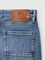 Blue de Gênes BGvinci Pala Used V3 Jeans in blue denim, featuring a regular fit, five-pocket design, and a tan leather brand patch on the back waistband.