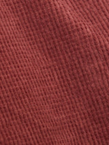 Close-up of Blue de Gênes Paulo Tucan Chino - Chipotle, an Italian-made textured brown fabric with fine ridges and a soft, knitted pattern. The cozy material has a slightly diagonal orientation across the image.