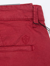 Close-up of Havana Red Teo Milano Shorts by Blue de Gênes, featuring a pocket, belt loop, and an embroidered shield emblem above the pocket. These shorts are made from a fine cotton/linen blend.