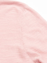 A close-up of the Monte Knit - Porcelain Pink by Blue de Gênes reveals a textured shoulder seam with fine stitching on its soft cotton/linen fabric.