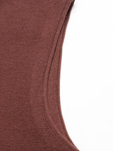 Close-up of the Zorba Knit Waistcoat in Prune by Blue de Gênes, featuring a brown ribbed Merino wool fabric with a visible curved seam on a white background.