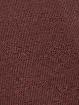 Close-up of the Zorba Knit Waistcoat from Blue de Gênes in a prune color, showcasing a woven pattern like textured fabric. It features a coarse grid formation with visible threads, creating a consistent and rustic look.