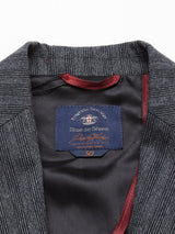 Close-up of a pinstriped Leopardi Dori Blazer from Blue de Gênes, made with Italian cotton-wool. A navy label shows the brand name. The maroon-edged lining complements the size 50 fit, reflecting Portuguese tailoring influences.