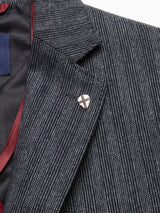 The Blue de Gênes Leopardi Dori Blazer in grey stripe features a shiny cross pin on the lapel, crafted from an Italian cotton-wool blend. It showcases Portuguese tailoring with a dark lining and contrasting maroon edge peeking out.