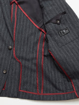 A close-up of the open Leopardi Dori Blazer from Blue de Gênes highlights Portuguese craftsmanship with a grey pinstripe design, black lining, maroon trim, and black buttons. The interior pocket holds a label, crafted from premium Italian cotton-wool blend.