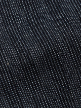 Close-up of dark blue denim fabric showcasing its textured weave, similar to the Italian cotton-wool blend in the Blue de Gênes Leopardi Dori Blazer - Grey stripe. The materials twill weave pattern highlights its durability and thickness.