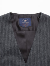 Close-up of a grey pinstriped Canna Dori Gilet from Blue de Gênes with a V-shaped opening, crafted from an Italian cotton-wool blend. The interior lining is black, and a blue label is sewn on the inside collar. Size 50.