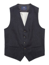 The Blue de Gênes Canna Santo Gilet in navy is a formal vest made from an Italian wool blend, featuring a V-neck, five center buttons, two lower front pockets, and striped lining, showcasing exquisite Portuguese tailoring.