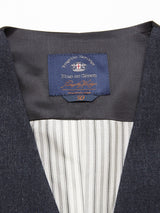 Close-up of a Canna Santo Gilet - Navy interior by Blue de Gênes, featuring a blue label with white and brown text. The white lining has black stripes on dark gray Italian wool blend fabric, showcasing a crest design and the number 50, highlighting its exquisite Portuguese tailoring.