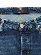Close-up of Blue de Gênes Repi Scan Used Jeans in mid-blue denim displaying button closure, front pockets, and waistband label. The craftsmanship is evident in the stitching and texture of the comfort stretch denim, providing stylish ease in every regular slim-fit pair.