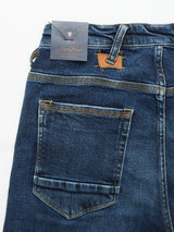 Repi Scan Used Jeans in mid-blue denim, branded Blue de Gênes, feature back pocket stitching and a leather waistband patch. A black Repi Jeans label is attached. These regular slim-fit jeans, crafted from comfort stretch denim, are displayed flat on a white background.