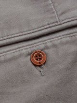 The Paco Papago Chino in Stormy Grey by Blue de Gênes features a garment-dyed pocket with visible stitching and a brown button, exuding refined style akin to textured moleskin chinos.
