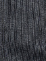 Close-up of Blue de Gênes Panco Dori Chino - Grey stripe. The fabric features thin vertical white pinstripes on dark material, indicating a lightweight Italian cotton-wool blend. Its soft, slightly wavy texture and irregular stripe pattern add subtle elegance for relaxed-fit chinos.
