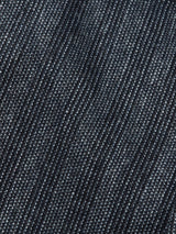 Close-up of Panco Dori Chino - Grey Stripe by Blue de Gênes, showcasing denim-like fabric with subtle irregular pinstripes. The texture blends dark and light blue threads, akin to relaxed fit chinos for a classic jean look.