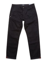 A pair of navy-colored Menzo Alvaro Chino trousers from Blue de Gênes is laid flat, featuring a button and zipper fly, side pockets, and a small embroidered detail on one pocket. The tapered leg design with comfort stretch material and turned-up cuffs reveals a thin red stripe inside.